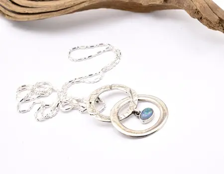 Opal pendant necklace with entwined circle design handmade from sterling silver