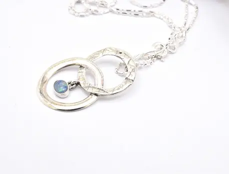 Opal pendant necklace with entwined circle design handmade from sterling silver