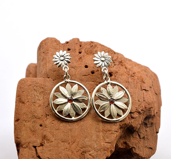 Handcrafted sterling silver earrings with floral design and red garnet stone
