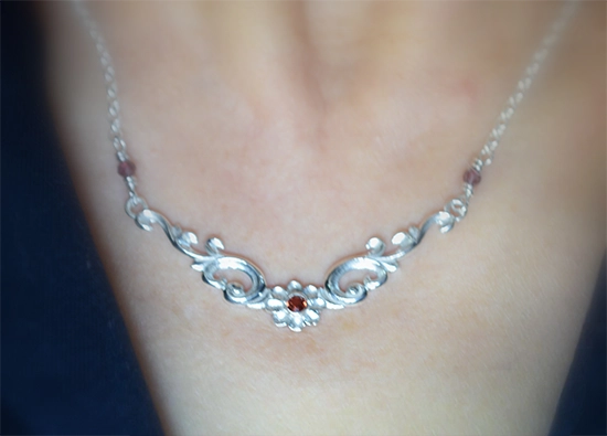 Floral silver necklace with natural garnet , neckline