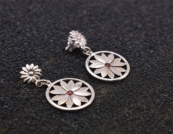 Sterling silver handmade flower earrings with tiny garnet gemstone detail